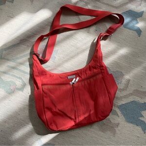 Baggalini Crossbody Sling Bag in Grapefruit